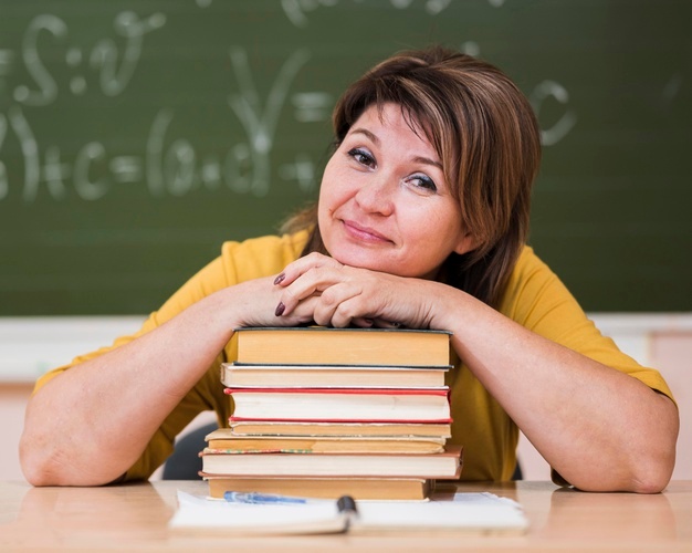 female-teacher-desk-sitting-stack-books_23-2148665942